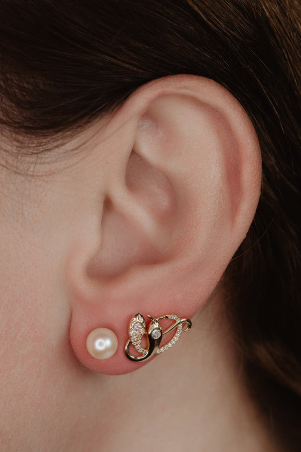 An artisan antique revival pair of solid 14k gold snake stud earrings. These snake earrings are made of pure 14 karat gold and are set with natural diamonds.  These earrings can be worn as a single stud or together as a pair. We have them both in white, rose and yellow gold, so please choose your preferred metal in the variations section.