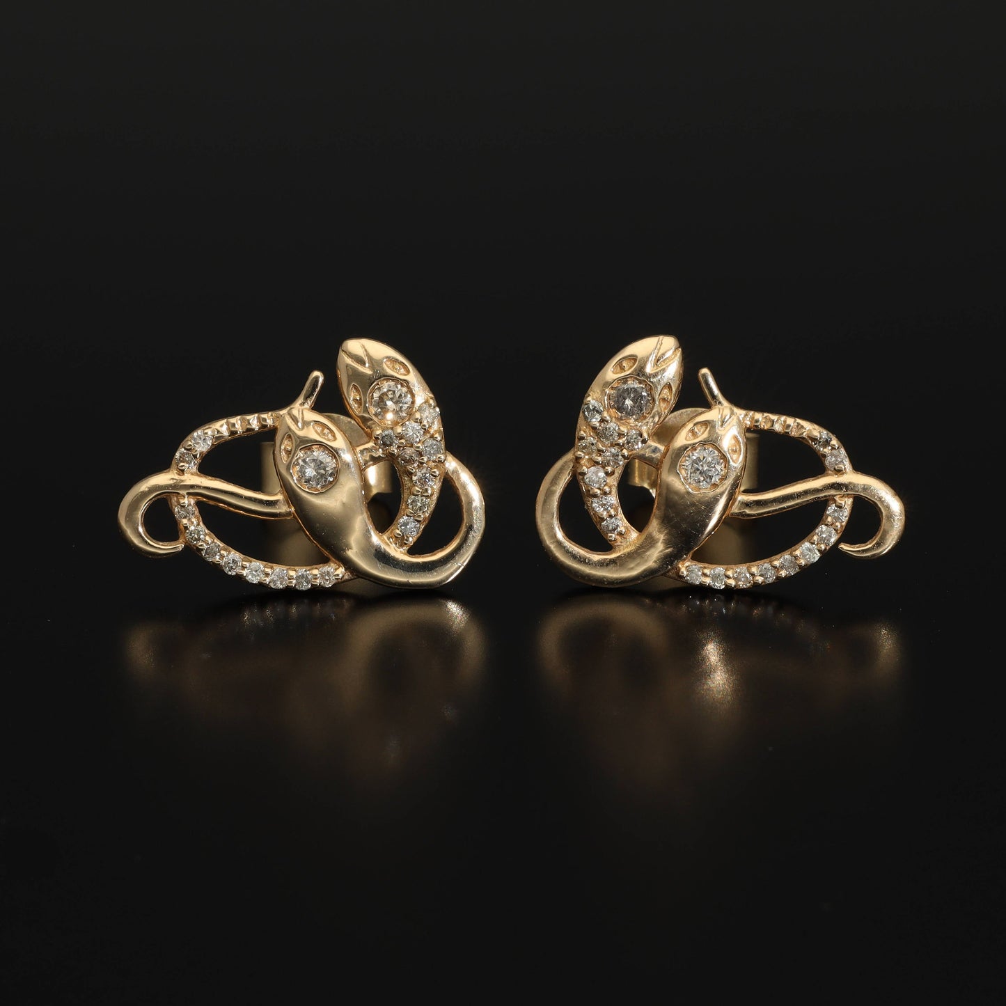 An artisan antique revival pair of solid 14k gold snake stud earrings. These snake earrings are made of pure 14 karat gold and are set with natural diamonds. These earrings can be worn as a single stud or together as a pair. We have them both in white, rose and yellow gold, so please choose your preferred metal in the variations section.
