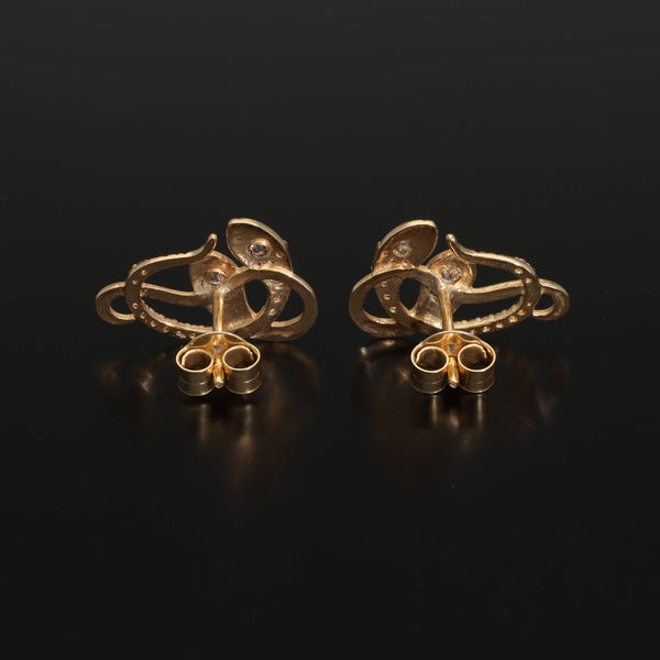 An artisan antique revival pair of solid 14k gold snake stud earrings. These snake earrings are made of pure 14 karat gold and are set with natural diamonds.  These earrings can be worn as a single stud or together as a pair. We have them both in white, rose and yellow gold, so please choose your preferred metal in the variations section.