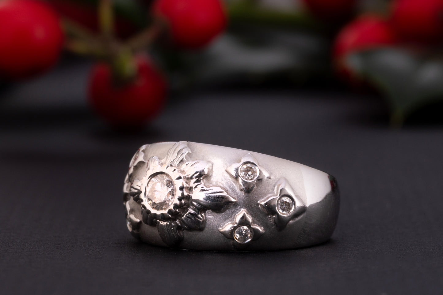 A white gold diamond starburst ring made of solid 18 ct gold and set with 0.35 ct worth of diamonds. The shank of this celestial ring is rather wide and puffy, the front part is brushed and has a velvet-like gold texture. The celestial centerpiece is set with 7 diamonds. The central diamond of 0.2 ct is set in an elevated 'star' setting and is surrounded by six smaller stones.