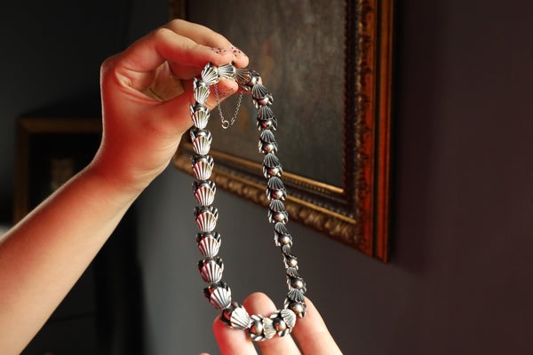 A statement vintage Art Deco necklace by Hermann Siersbøl, Denmark. Dating circa late 1940s, this flower necklace is handmade from solid sterling silver and is 18 inches long. The necklace has a stunning Art Deco style floral profile with a deliberate reverse inner side. The chain is 40 cm or 16 inches long and has an extra security chain to protect it from falling.

A beautiful example of Danish 1940s jewelry, this handmade designer chain will make an amazind daily eye-catcher. This chain necklace has a ha