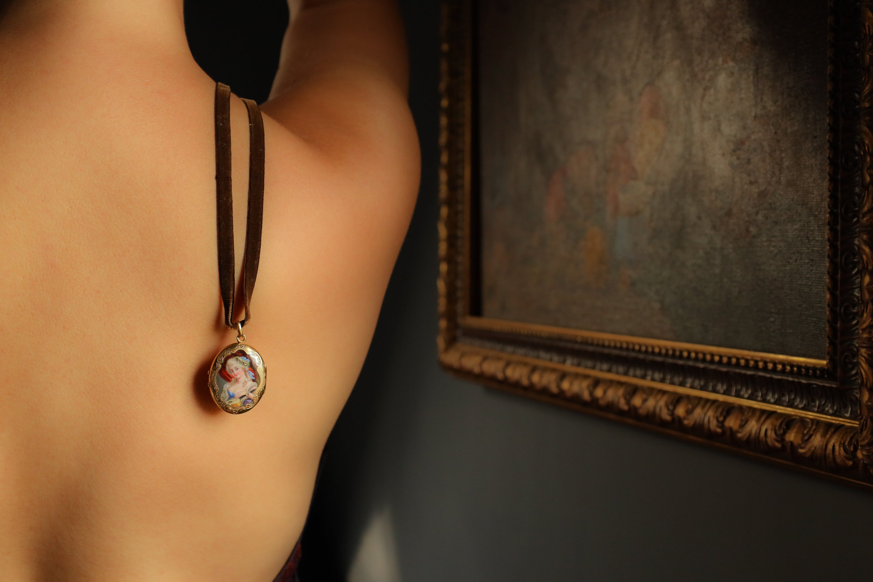 Necklace with a pendant worn by a person, with a blurred background