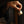Hand holding a gold ring with a dark background