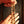 Close-up of hands holding a necklace with a dark background