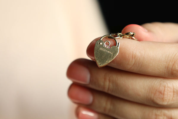 Gold heart-shaped pendant on a blurred background
