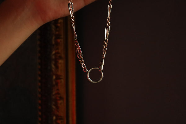 Close-up of a necklace with a pendant on a dark background