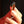 Hand holding a decorative ring with intricate design against a dark background