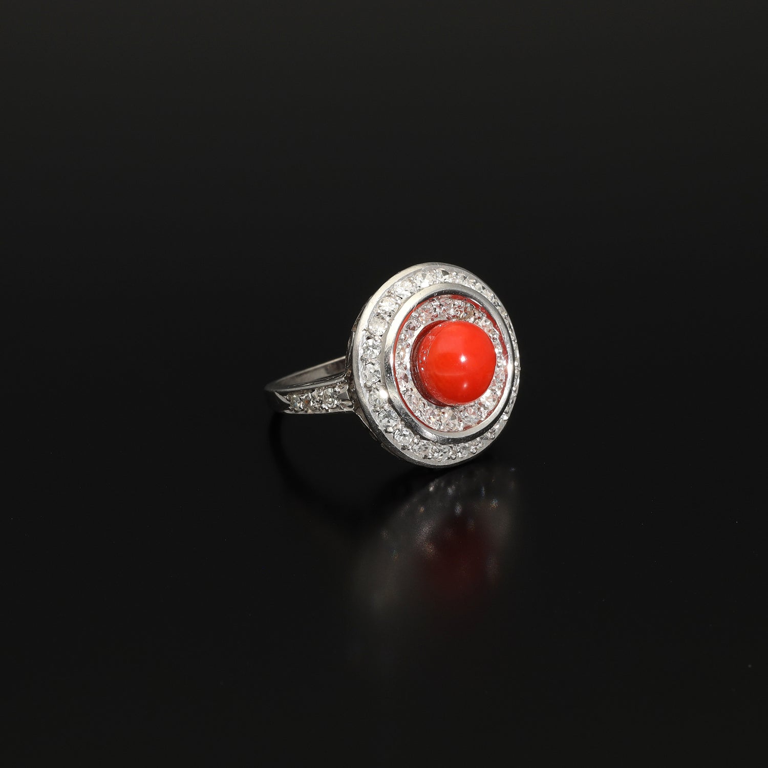 Absolutely STUNNING Art Deco coral and diamond ring. Born in the South of Italy, this magnificent ring is crafted in solid 18 kt white gold! The ring is heavy - it weights whooping 8 grams - and is preserved in a superb state. The round crown is set with a lovely Sicilian coral surrounded by a double halo of 40 sparkling diamonds.