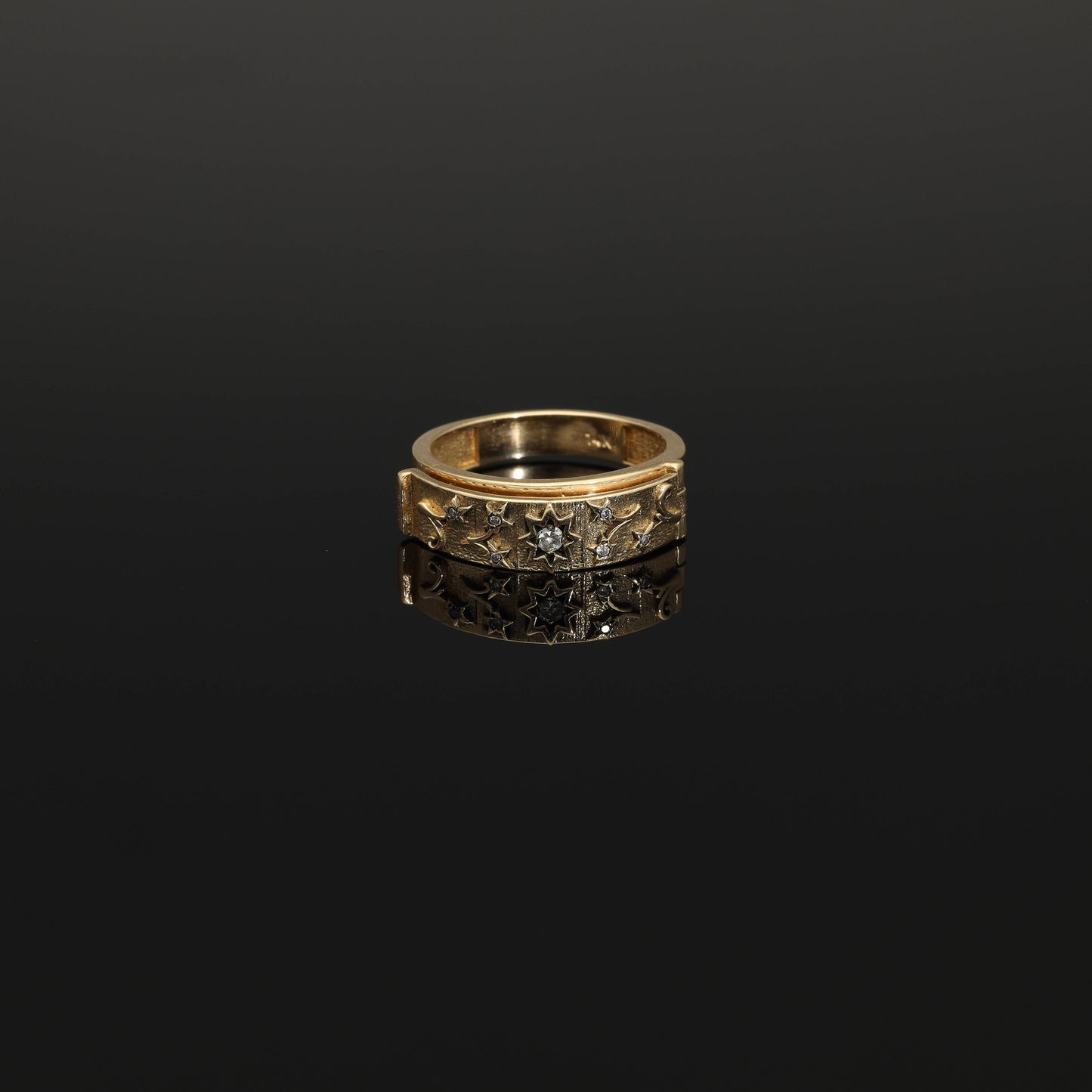 A unique unisex diamond secret compartment ring in solid 14k gold. This yellow gold so-called poison ring opens to a secret compartment which reads DARLING. A modern twist on Victorian era sentimental jewelry, this beautiful ring is produced on demand by our workshop.  The face of the ring has a celestial ornament depicting a star surrounded by foilate.