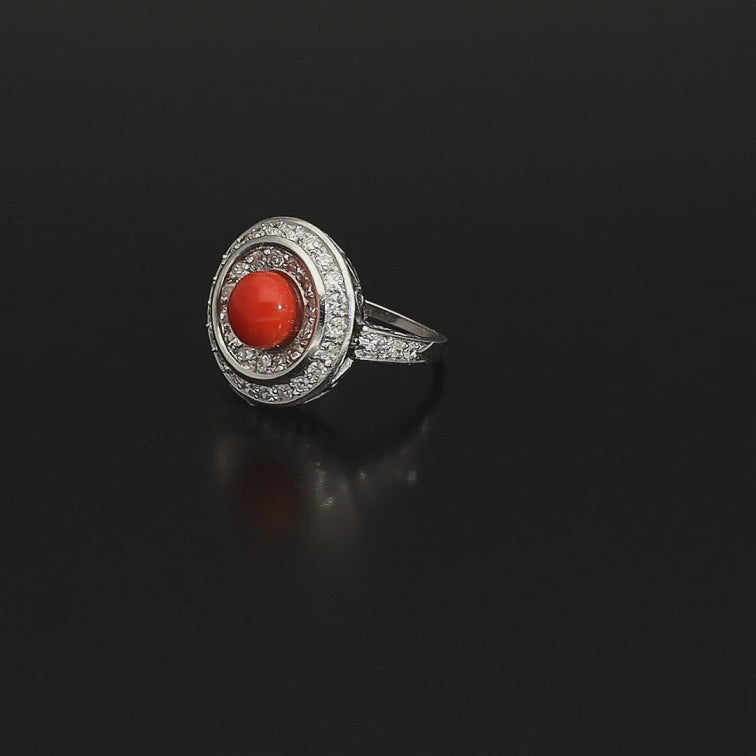 Absolutely STUNNING Art Deco coral and diamond ring. Born in the South of Italy, this magnificent ring is crafted in solid 18 kt white gold! The ring is heavy - it weights whooping 8 grams - and is preserved in a superb state. The round crown is set with a lovely Sicilian coral surrounded by a double halo of 40 sparkling diamonds.